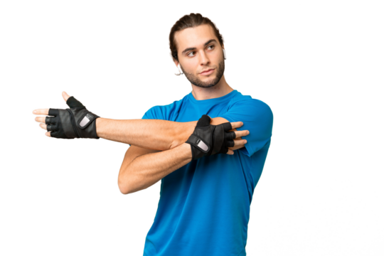 Young handsome man isolated on green chroma background stretching arm