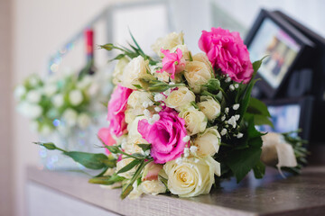 Pink and white wedding bouquet on the wooden table, selective focus