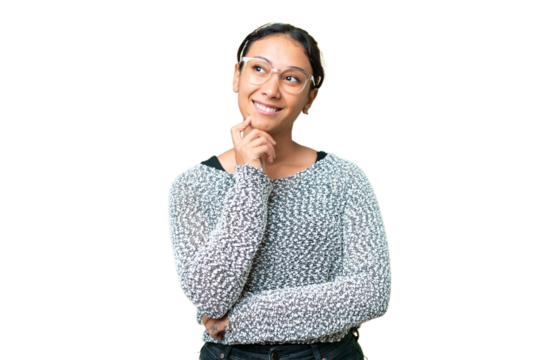 Young Uruguayan woman over isolated chroma key background thinking an idea while looking up
