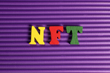 word NFT, non-fungible token, from colored letters