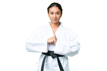 Young Uruguayan woman over isolated chroma key background doing karate and saluting © luismolinero