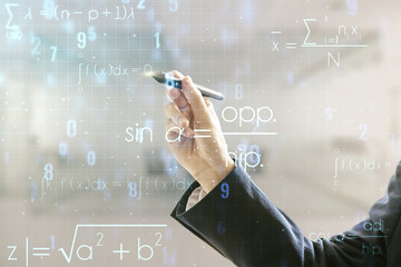 Man hand with pen working with abstract scientific formula hologram on blurred office background. Multiexposure