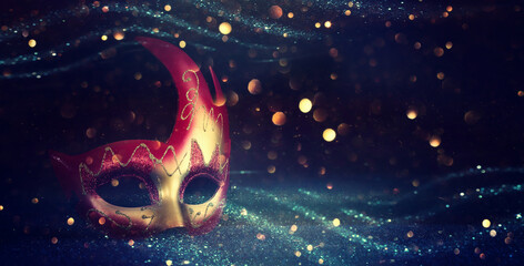 Image of elegant venetian mask over glitter background