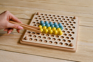 Children's educational wooden game. The study of colors. Montessori concept, early brain training. Early education, fine motor skills.