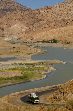 Beautiful landscape in Kurdistan as a bus winds its way along a road beside the River Zab, in the Kurdish region of North Iraq, Middle East.