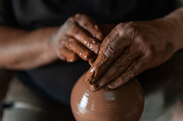 Potter at work making traditional local clay pottery in the Turkish town of Avanos on the river Kızılırmak in Cappadocia, Turkey. - obrazy, fototapety, plakaty