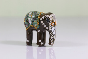 Traditional Indian souvenir. Decorative elephant sculpture on mirror background