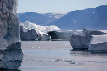 Iceberg with arch in the Uummannaq Fjord a large fjord system in the northern part of western Greenland, Denmark