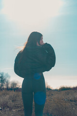 Backlit young model in the field.
