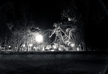 Mountain biker manuals across a park bench.