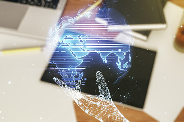 Abstract creative world map and modern digital tablet on background, top view, international trading concept. Multiexposure