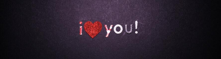 on a dark background, a heart and an inscription - I love you in multi-colored letters