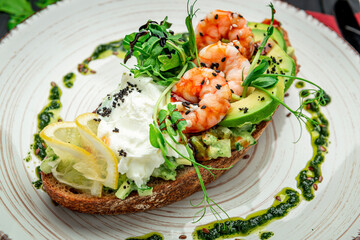 Bruschetta with shrimp, guacamole, cream cheese and pesto sauce.