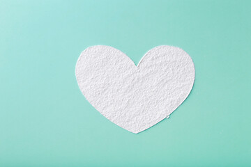 Heart shaped flour close up on a colored background. A pile of flour on a a colored background. Spilled flour. Flour texture