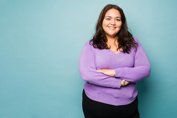 Fat latin young woman looking happy