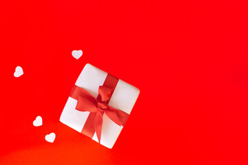 White gift box with red ribbon isolated on red color background.valentine's background. Greeting card template