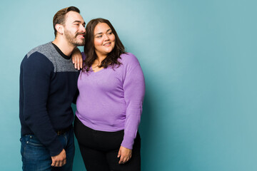 Happy young couple looking at copy space ad