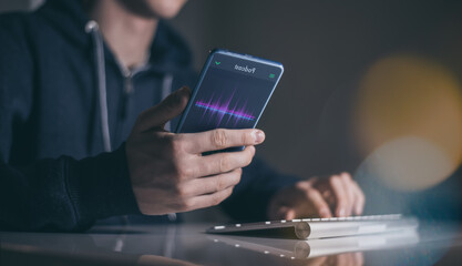 Teen with smartphone playing podcast in hand. Radio broadcast, music and audio streaming concept.