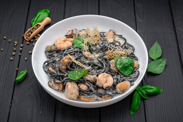 Plate of black spaghetti with prawn, mussels