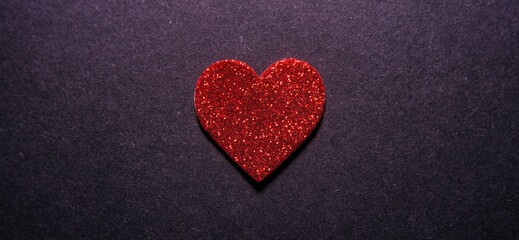 red heart on black background