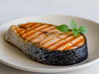 grilled salmon steak on plate side view