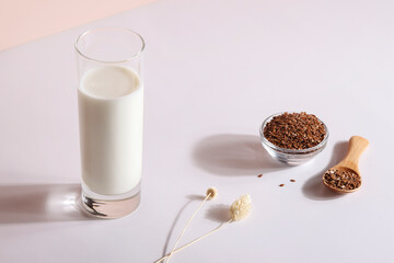 flax seed milk in glass on white background with plant. copy space. Raw diet meal. Healthy vegetarian food and lifestyle. eco friendly product