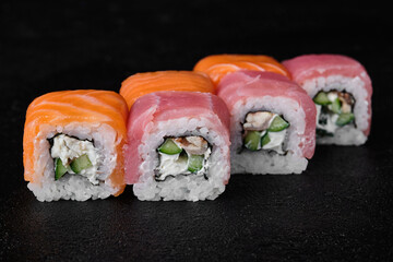 Three kind of fish sushi roll. Salmon, Tuna, Eel sushi roll on black background