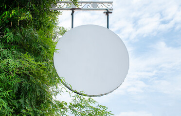 Outdoor white circle sign with blue sky background
