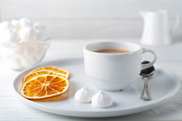 Coffee with cream, fluffy protein cake and dried oranges