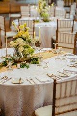 Beautiful table setting decorated with lighted candles, tableware, flowers, accessories for a...