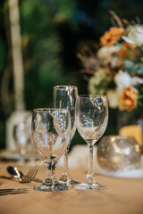 Beautiful table setting with tableware, flowers, candles, accessories and rose centerpiece for a party, wedding reception, gala banquet or other holiday event.