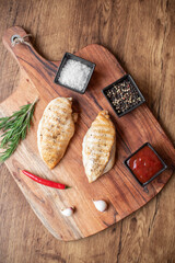 grilled chicken fillet on wooden background
