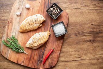 grilled chicken fillet on wooden background