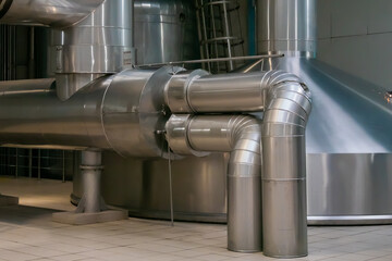 Steel pipes and tank for wort boiling at beer factory - brewery equipment. Production, manufacture, industrial concept
