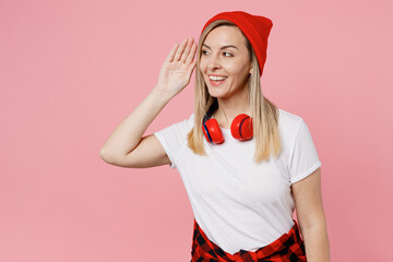 Young curious nosy happy cheerful woman wear white t-shirt red hat try to hear you overhear...