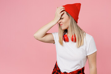 Young dissatisfied woman wear white t-shirt red hat put hand on face facepalm epic fail mistaken...