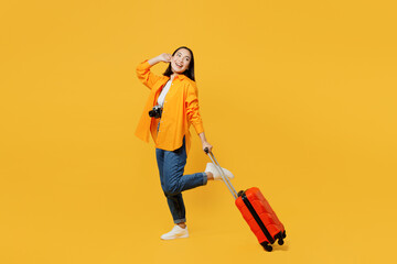 Young woman in summer casual clothes stand with suitcase bag hold face look aside isolated on plain...