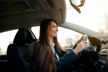 Young woman driving car in the city.