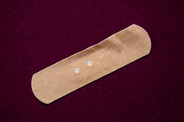 First aid plaster isolated on color background. Top view.