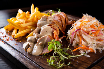 baked meat in mushroom sauce with potato and salad