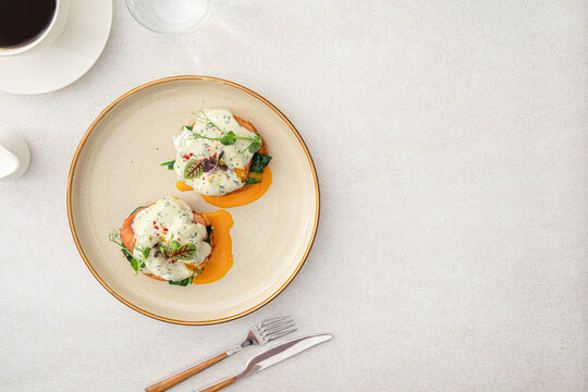 Top view on portion of benedikt egg with dor-blue sauce