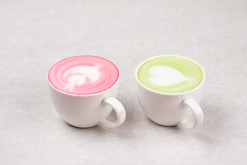 Side view on two cups of different matcha latte drinks