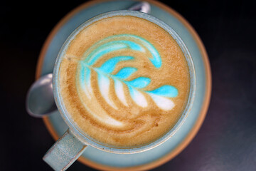 A cup of cappuccino coffee on a table in a cafe. Coffee hot drink in a ceramic cup for breakfast in the morning.