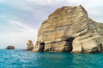 Caves and rock formations by the sea at Sarakiniko area in Milos island, Greece