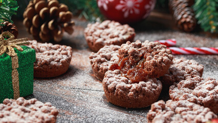 Christmas chocolate mince pies with decoration, gifts, green tree branch on wooden rustic table