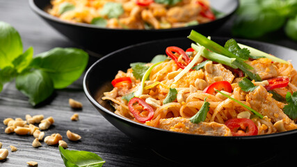 Chicken Pad Thai with eggs, bean sprouts, peanuts and spring onion