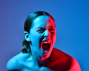 Head and shoulders close up portrait of pretty girl with expressive facial expressions, with  colourful neon gel lighting, isolated on studio background.