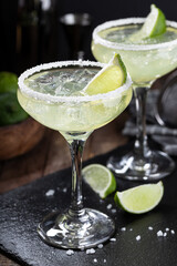  Margarita cocktail with ice, lime and salt rim