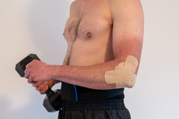 Physiotherapy treatment with therapeutic tape for elbow pain. 