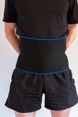 A man with a support warming belt using to protect spine or weight loss.